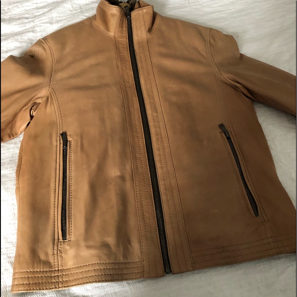 Andrew Marc tan leather coat with fur lining.